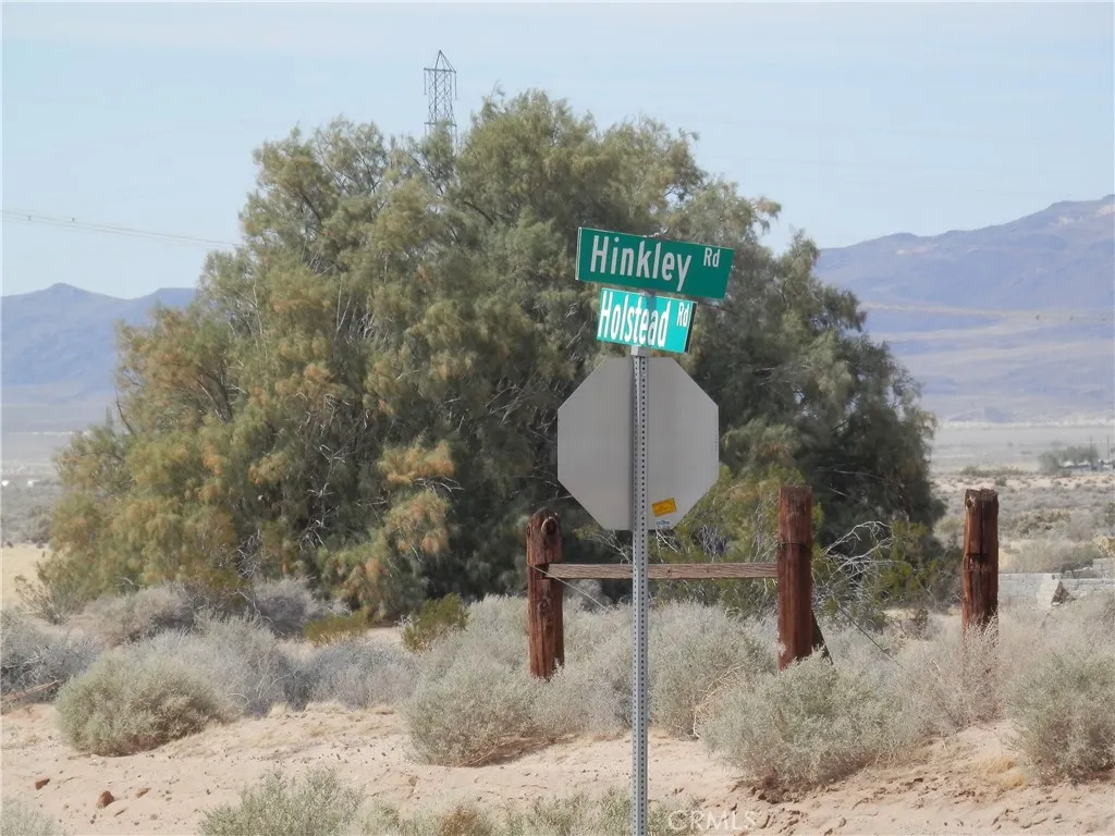 0 Holstead Hinkley, CA 92347 - Photo 2 of 15 a front view of a house with a yard and mountain view