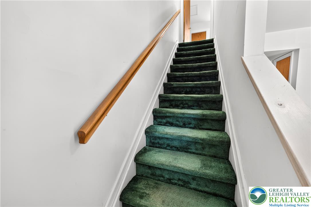 168 Springhouse Road Allentown, PA 18104 - Photo 21 of 49 Ascend to comfort on a green carpeted staircase, connecting living spaces seamlessly.