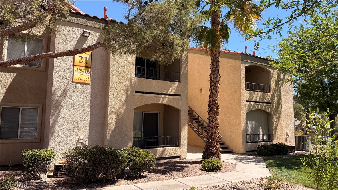 7885 West Flamingo Road, Unit 1131 Las Vegas, NV 89147 - Photo 7 of 36 A terracotta-tiled roof crowns this multi-story residence, complemented by desert-friendly landscaping.