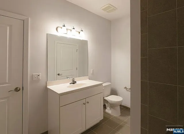 a bathroom with a tub a shower and a sink
