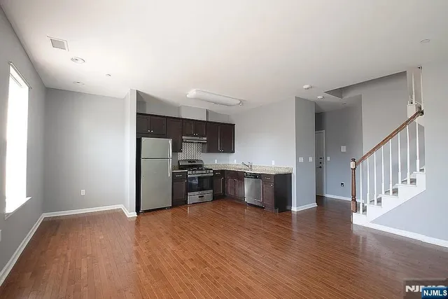 a view of a kitchen with a sink and a stove top oven