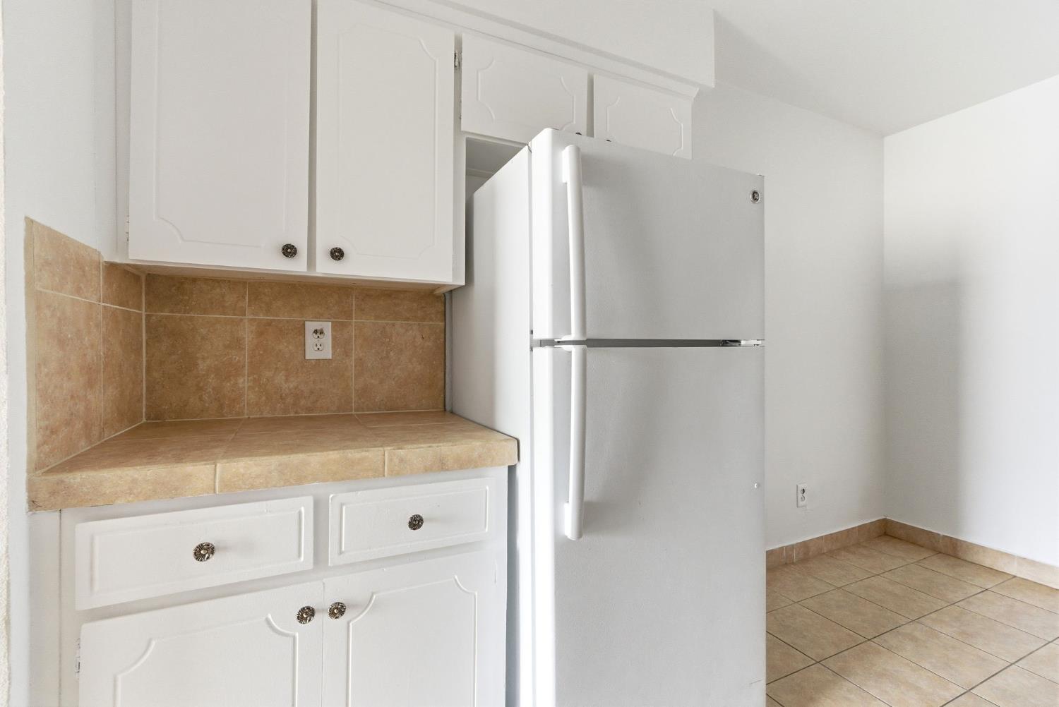 616 South Irwin Street, Unit C Hanford, CA 93230 - Photo 12 of 26 a white refrigerator freezer sitting inside of a kitchen