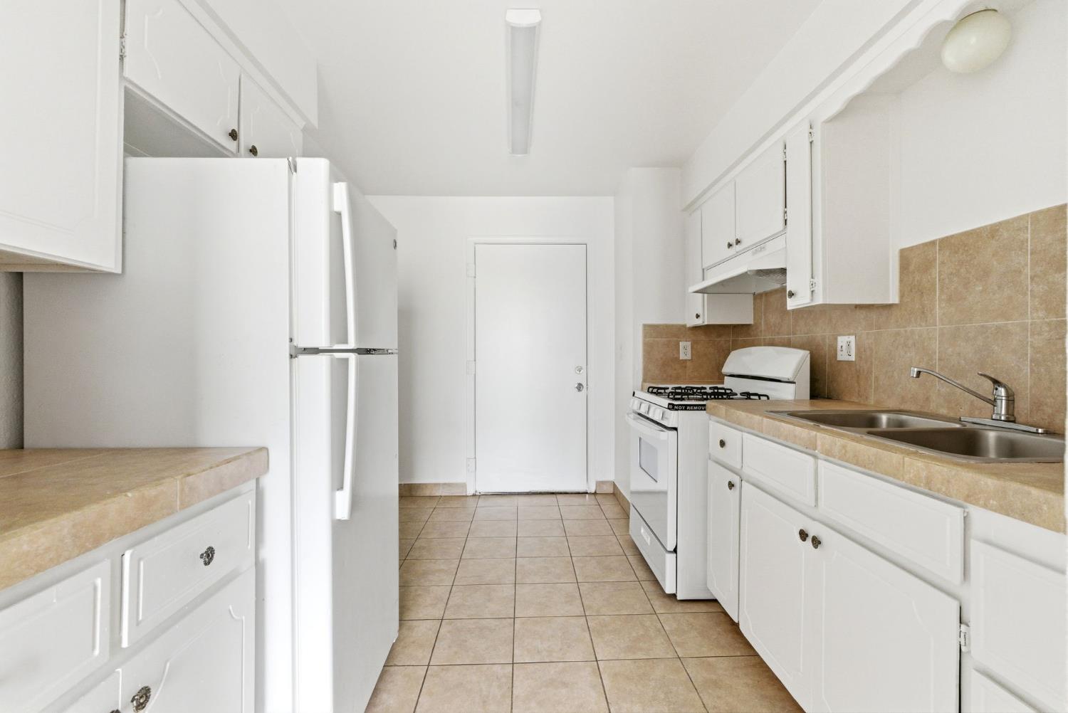 616 South Irwin Street, Unit C Hanford, CA 93230 - Photo 15 of 26 a kitchen with stainless steel appliances a refrigerator sink and cabinets