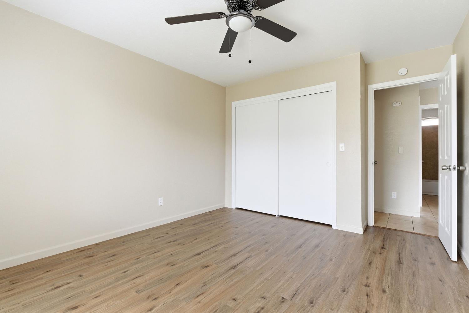 616 South Irwin Street, Unit C Hanford, CA 93230 - Photo 19 of 26 an empty room with wooden floor and ceiling fan