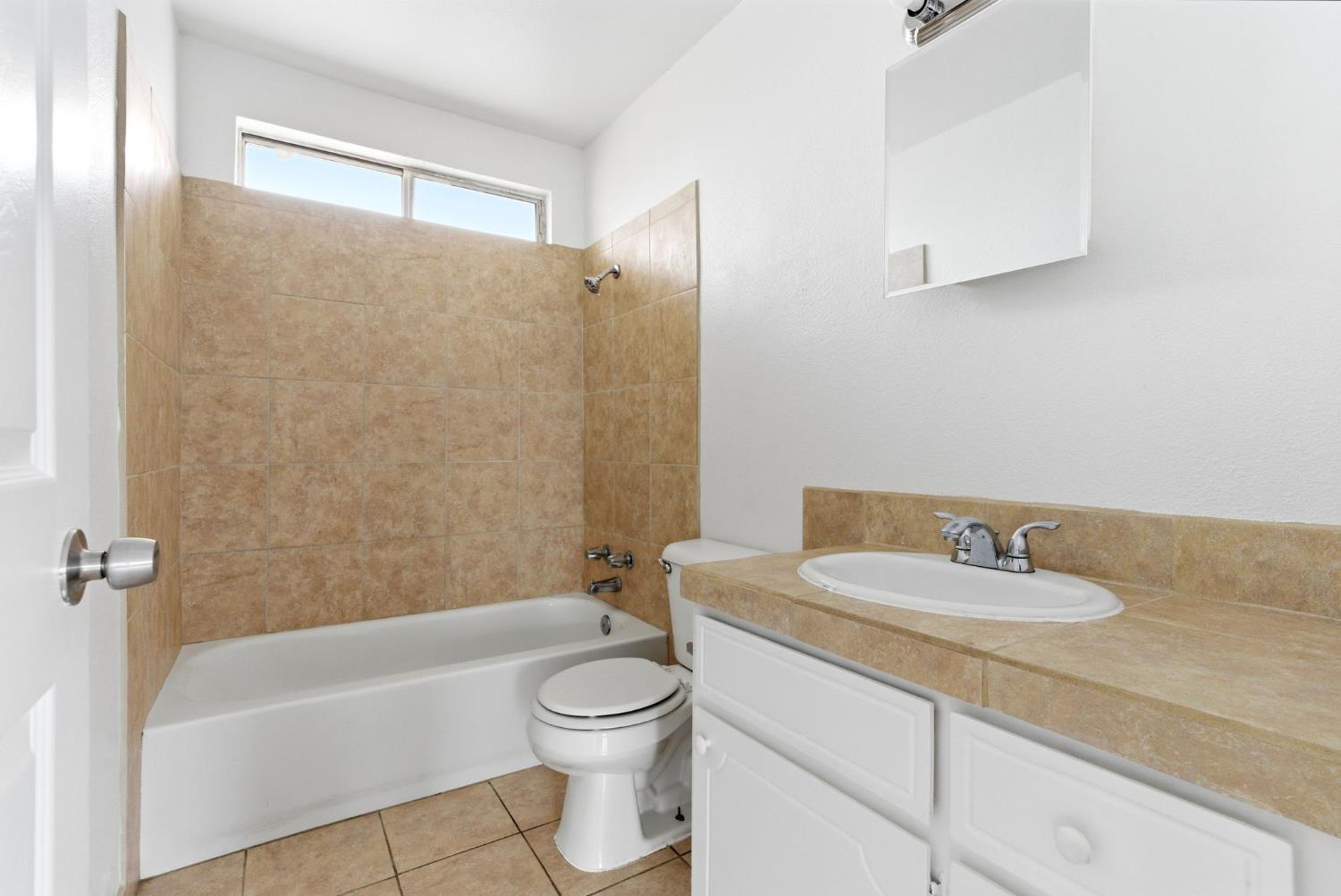 616 South Irwin Street, Unit C Hanford, CA 93230 - Photo 20 of 26 a bathroom with a sink a toilet and bathtub