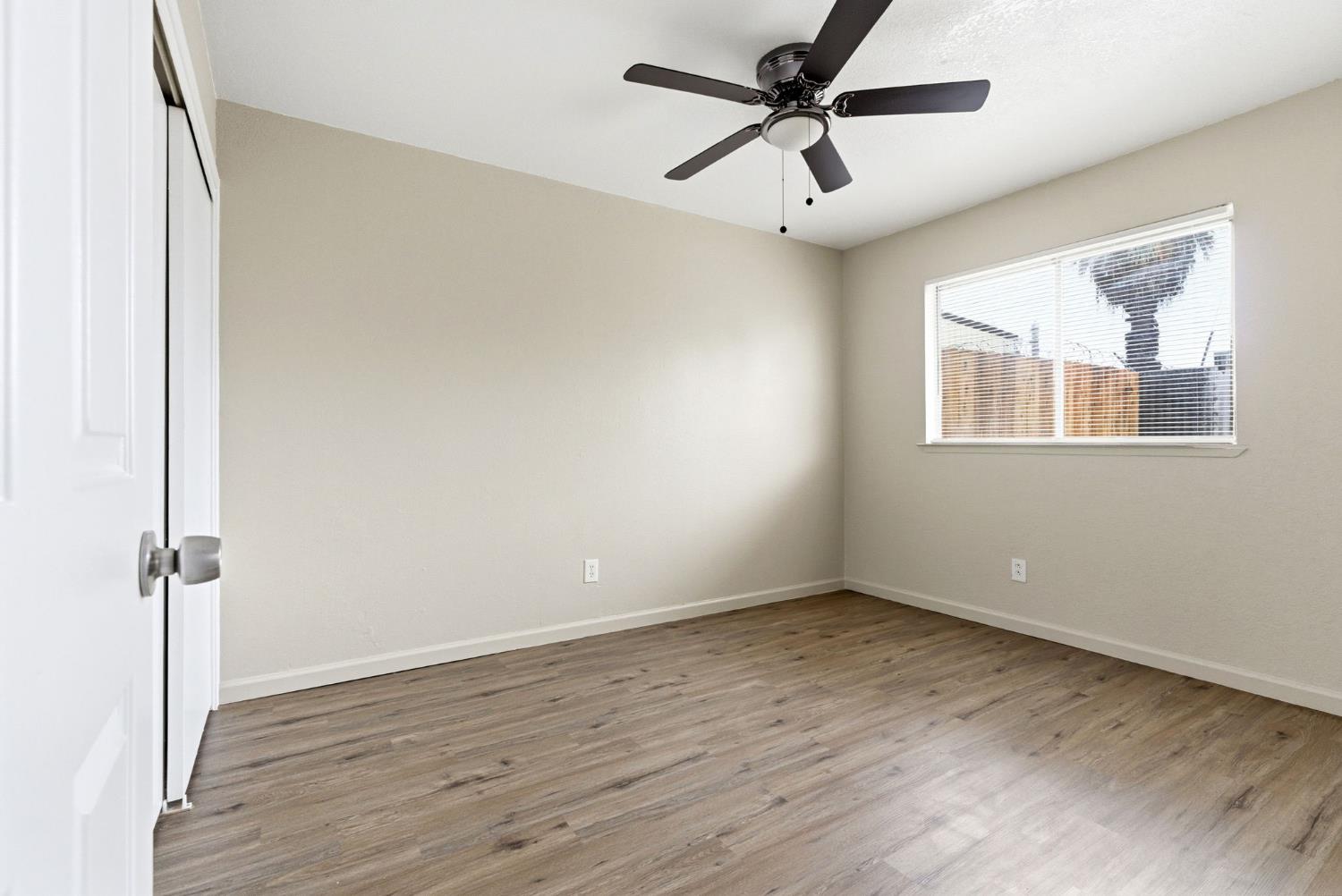 616 South Irwin Street, Unit C Hanford, CA 93230 - Photo 22 of 26 wooden floor in an empty room with a window