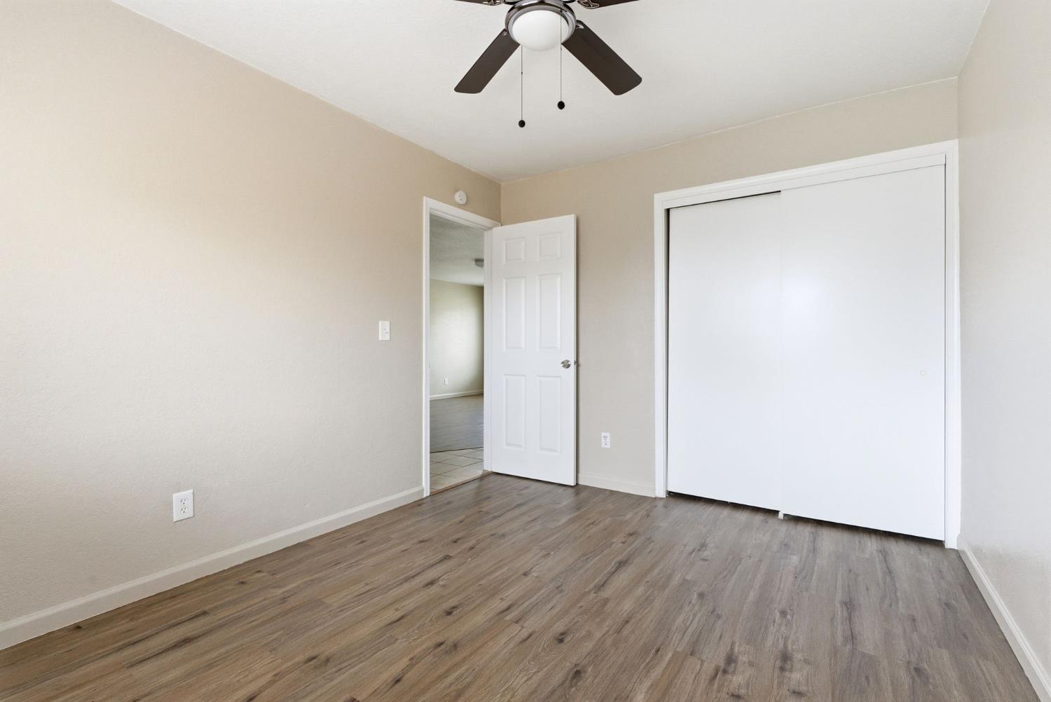 616 South Irwin Street, Unit C Hanford, CA 93230 - Photo 23 of 26 an empty room with wooden floor and windows