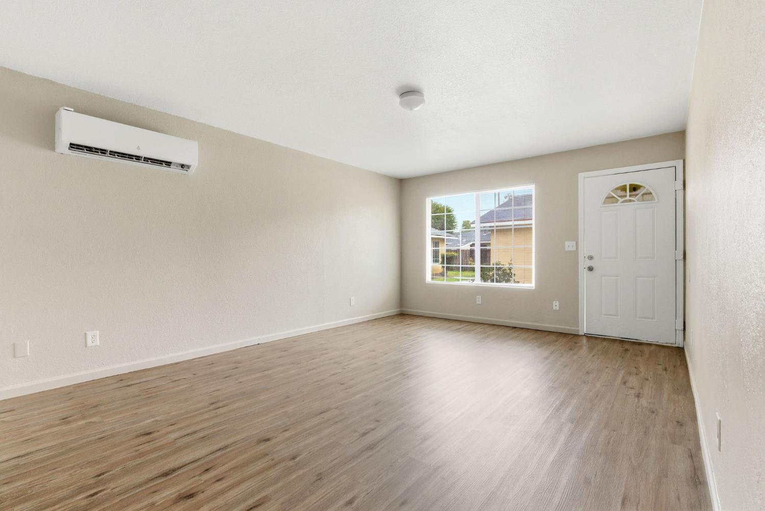 616 South Irwin Street, Unit C Hanford, CA 93230 - Photo 8 of 26 wooden floor in an empty room with a window