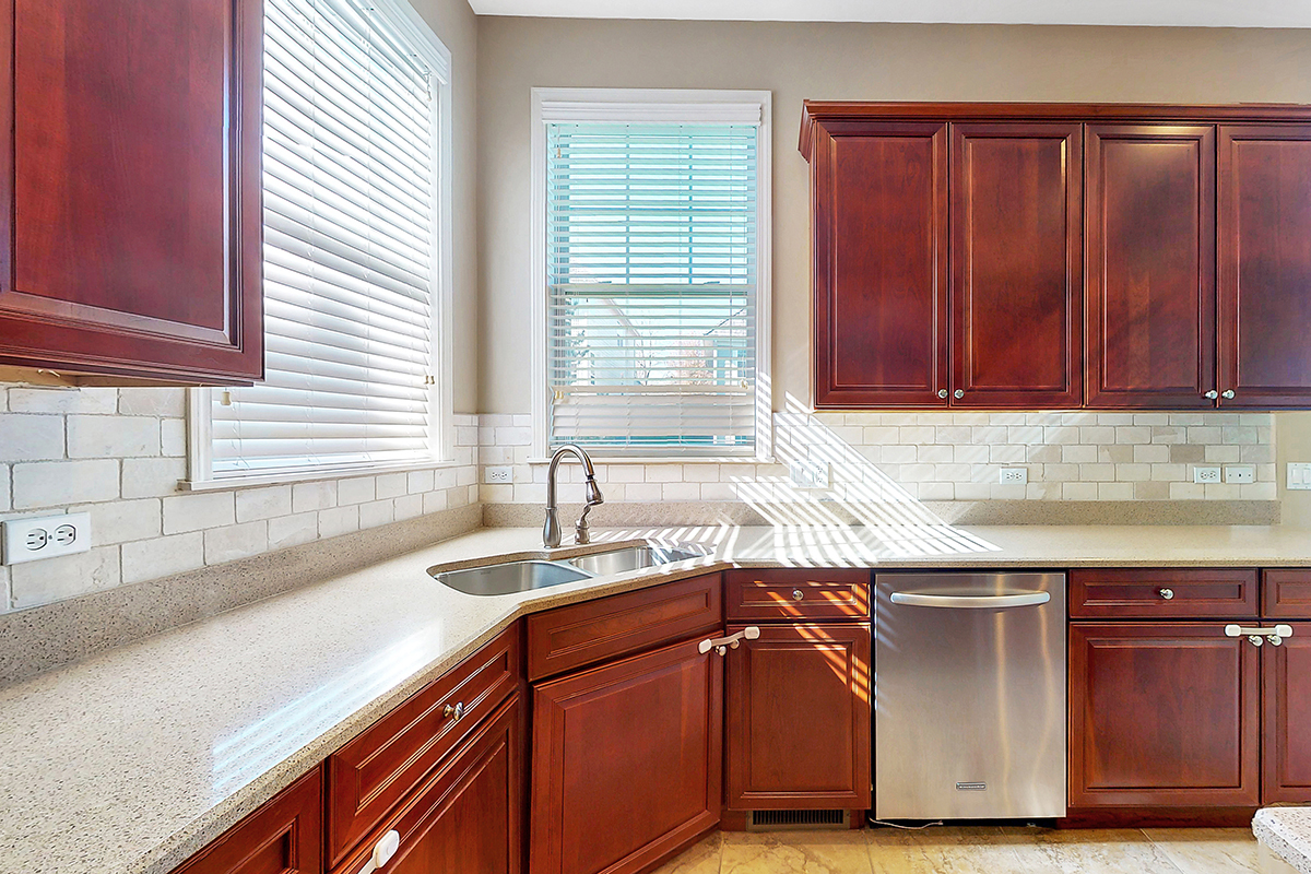 1118 Ashley Lane Inverness, IL 60010 - Photo 21 of 50 a kitchen with stainless steel appliances granite countertop a sink and a wooden cabinets