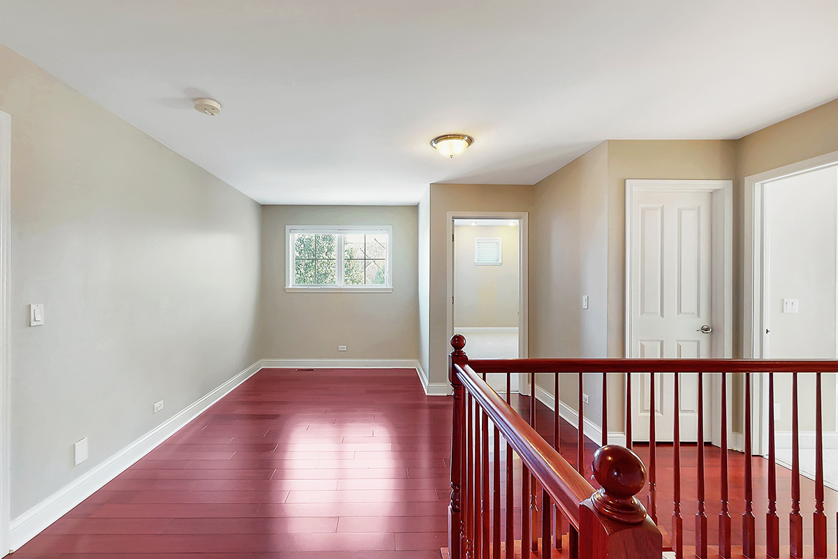 1118 Ashley Lane Inverness, IL 60010 - Photo 23 of 50 a view of a hallway with wooden floor and windows