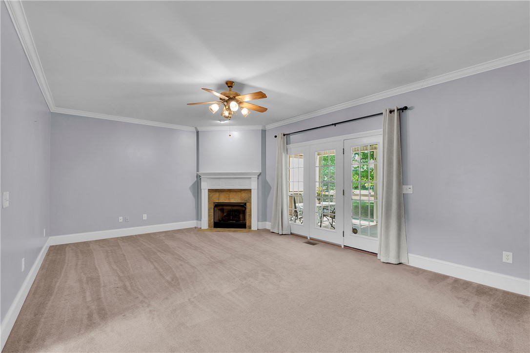 406 Hopewell Ridge Anderson, SC 29621 - Photo 14 of 46 This living area features a warm fireplace and bright French doors leading to outdoor leisure.