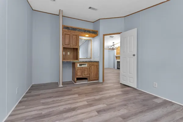 a view of kitchen with refrigerator and wooden floor