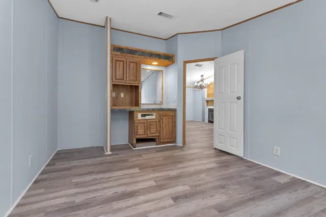 a view of kitchen with refrigerator and wooden floor