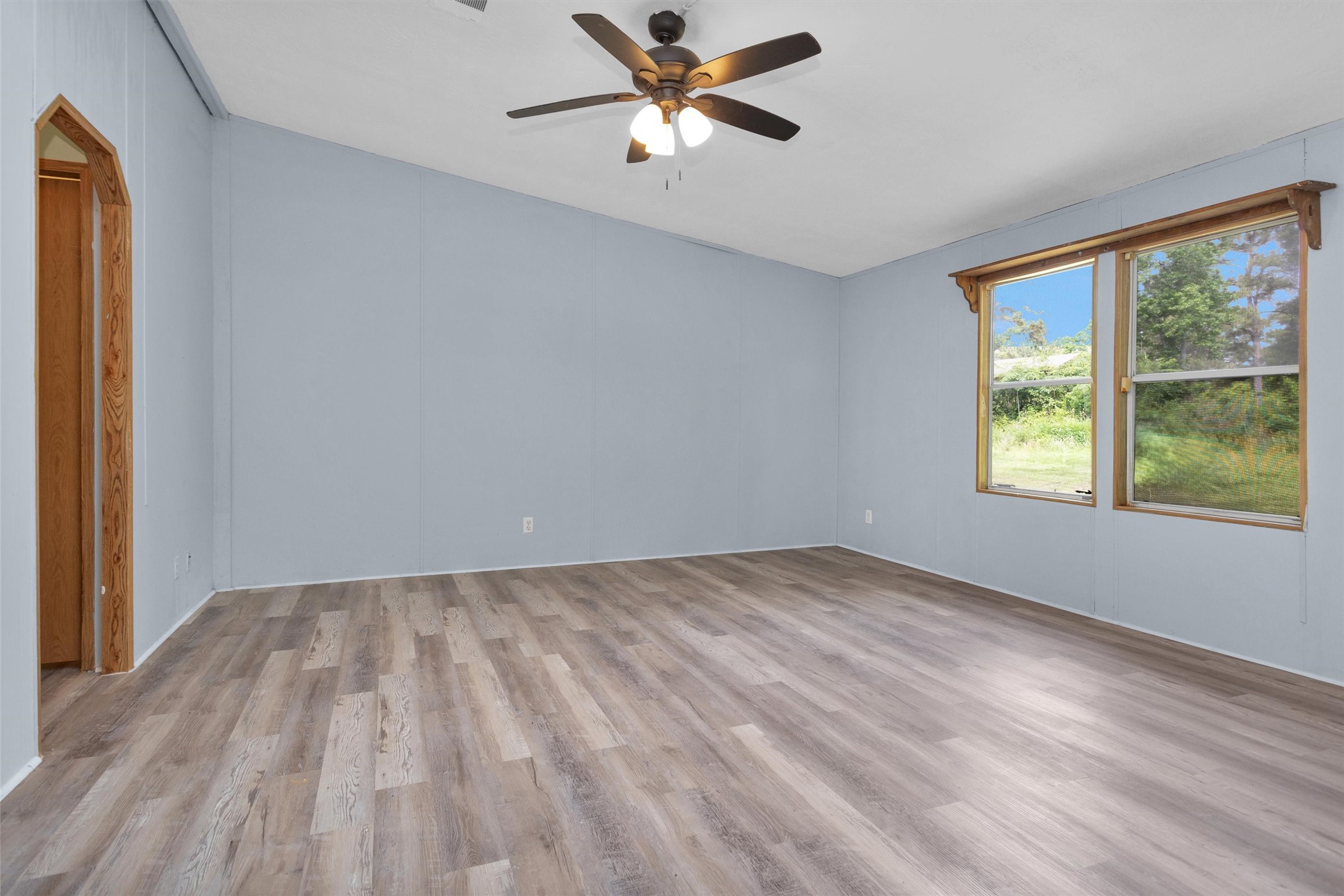 1001 County Line Road Shepherd, TX 77371 - Photo 12 of 46 wooden floor in an empty room with a window