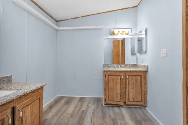 a view of hallway with wooden floor