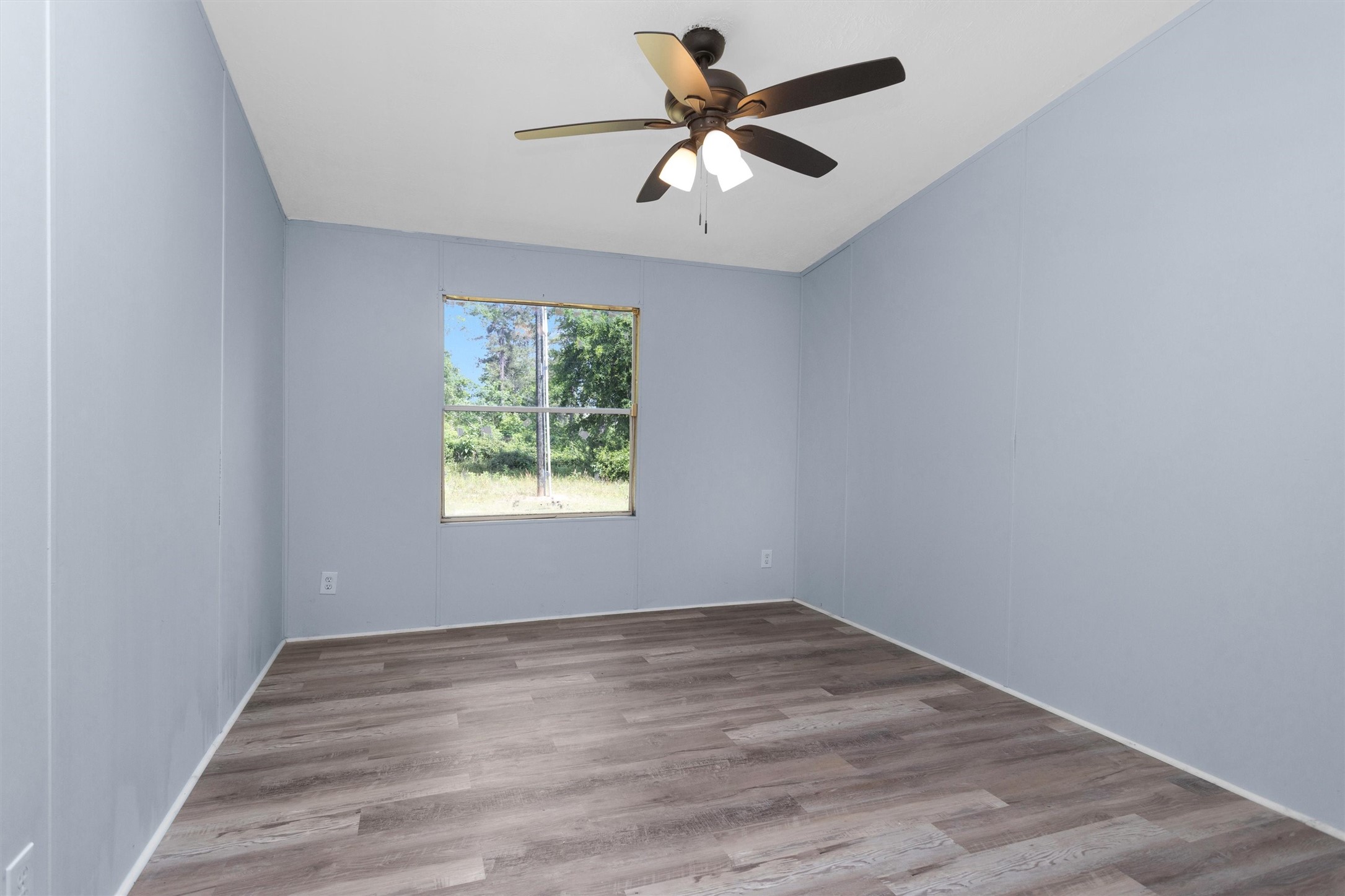 1001 County Line Road Shepherd, TX 77371 - Photo 28 of 46 an empty room with a window and a fan