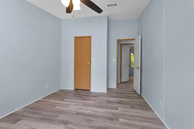 a view of hallway with wooden floor