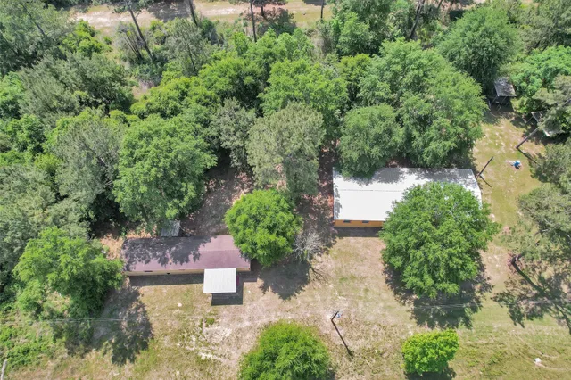 an aerial view of a house with a yard
