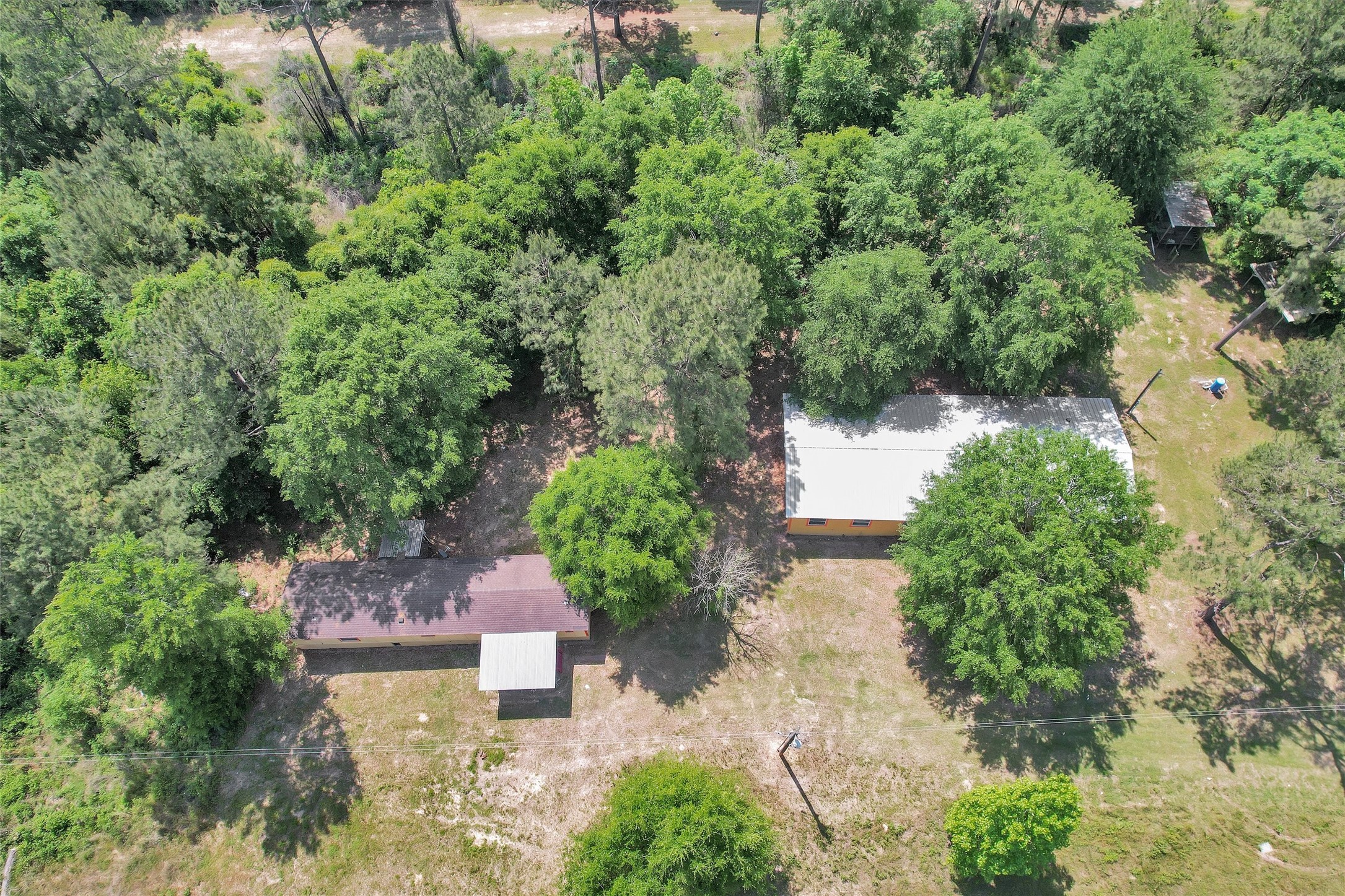 1001 County Line Road Shepherd, TX 77371 - Photo 3 of 46 an aerial view of a house with a yard