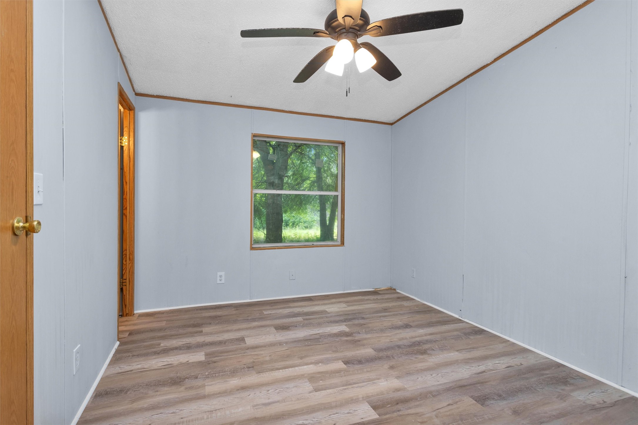 1001 County Line Road Shepherd, TX 77371 - Photo 31 of 46 an empty room with window and ceiling fan