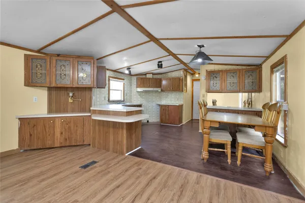 a kitchen with a table and chairs in it