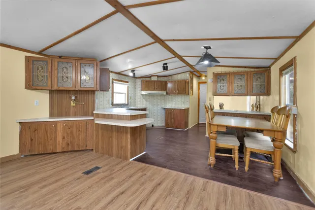 a kitchen with a table and chairs in it