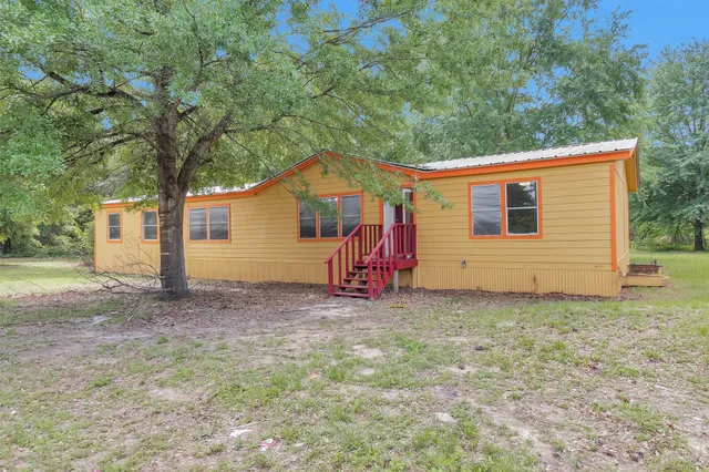 a backyard of a house with oven and garden