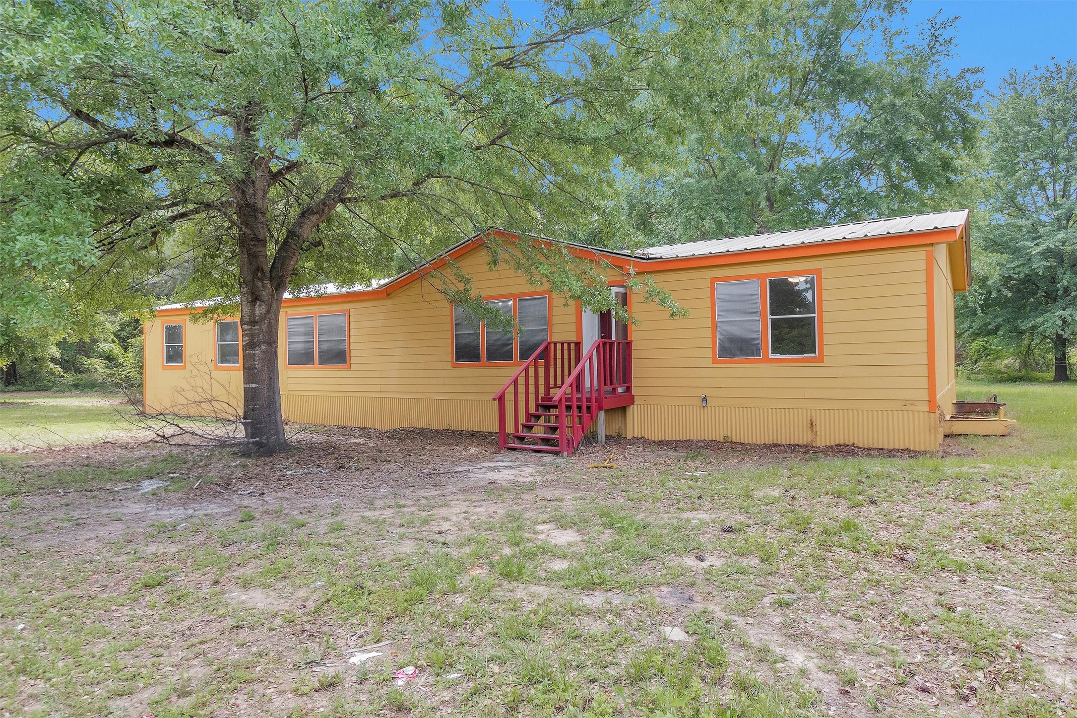 1001 County Line Road Shepherd, TX 77371 - Photo 5 of 46 a backyard of a house with oven and garden