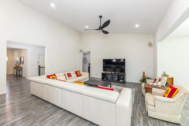 a living room with furniture and a wooden floor