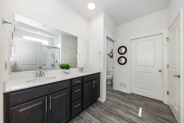 a spacious bathroom with a double vanity sink and a mirror