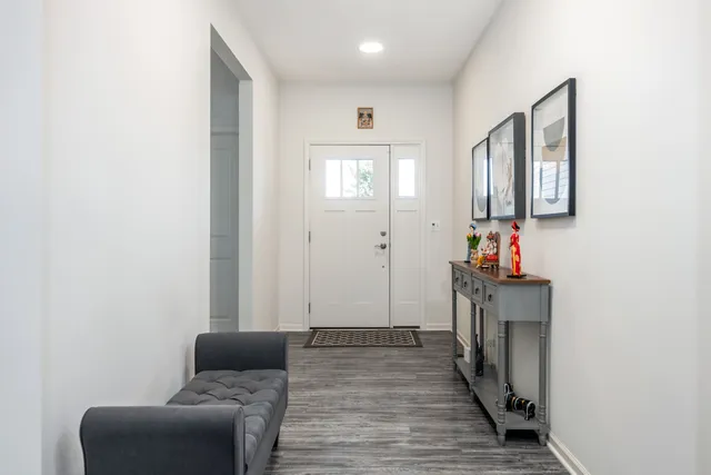 a hallway with furniture and wooden floor