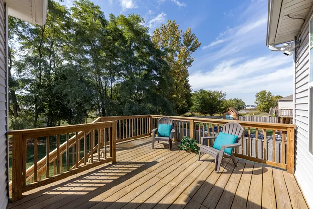 a view of balcony with wooden floor and fence