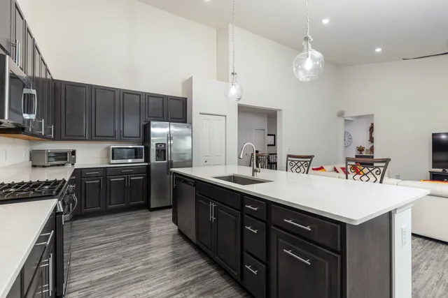a kitchen with a sink cabinets and wooden floor