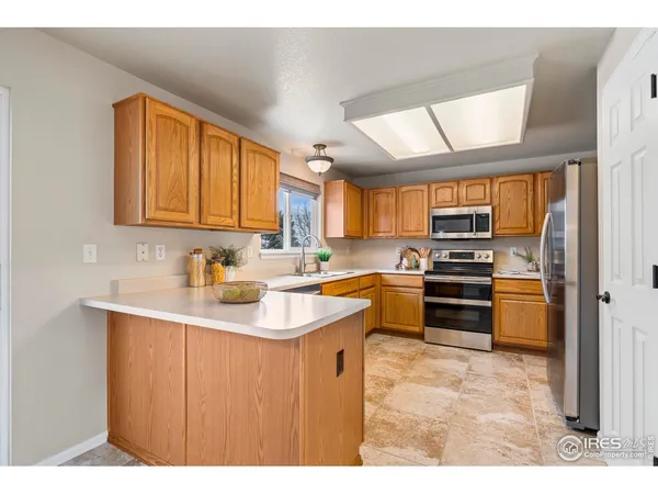 a kitchen with stainless steel appliances a sink stove and cabinets