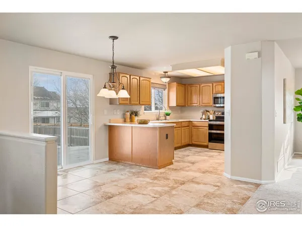 a kitchen with kitchen island a sink stainless steel appliances and cabinets