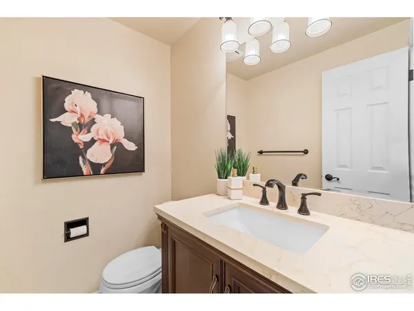 a bathroom with a sink a mirror and a toilet