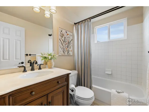 a bathroom with a sink toilet a mirror and shower