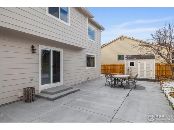 a backyard of a house with outdoor seating