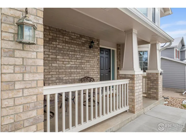 a view of a brick house with wooden fence