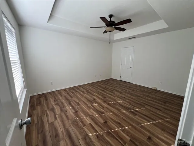 a view of a room with a ceiling fan