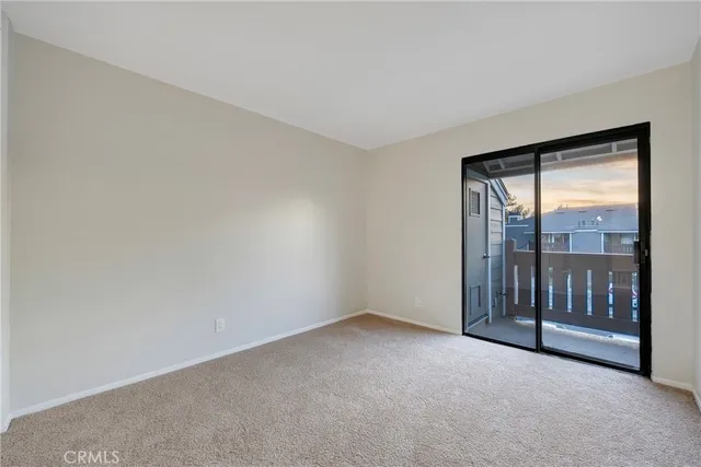 a view of an empty room with glass door