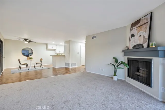 a view of empty room with wooden floor and fireplace