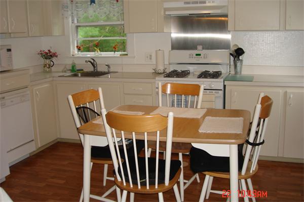 172 Telegraph Road Dennis, MA 02639 - Photo 4 of 9 a kitchen with granite countertop a dining table chairs and a stove