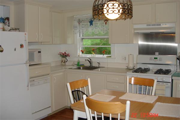 172 Telegraph Road Dennis, MA 02639 - Photo 5 of 9 a kitchen with stainless steel appliances granite countertop a sink a stove a dining table and chairs