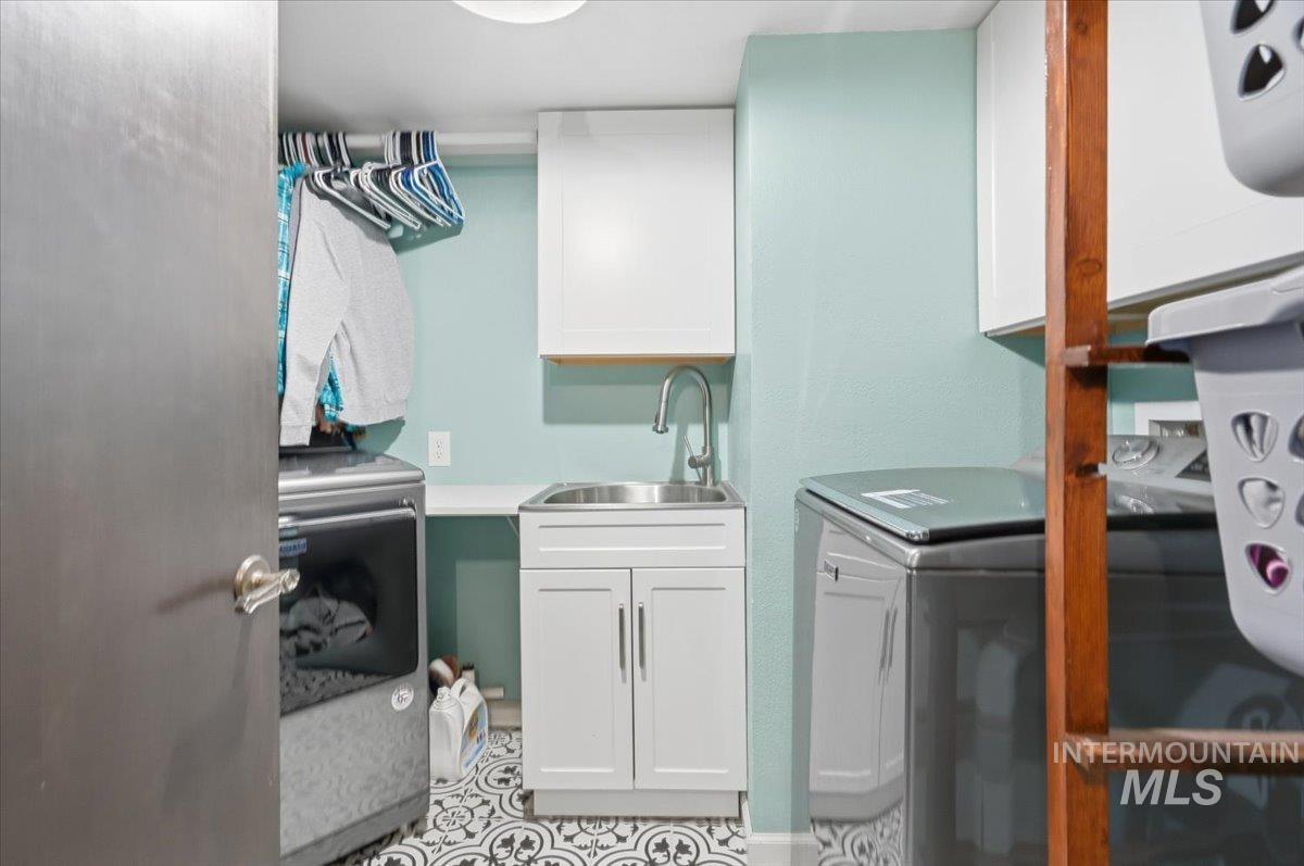 7771 Elmore Road Fruitland, ID 83619 - Photo 30 of 48 Laundry room featuring cabinet space and water heater