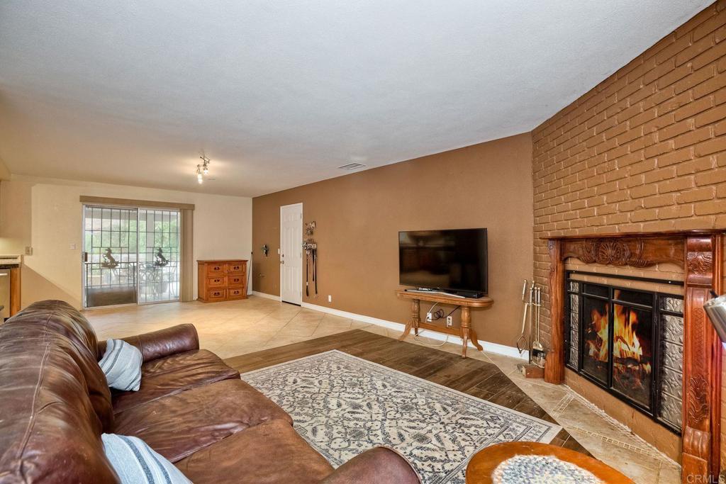 548 Taylor Street Vista, CA 92084 - Photo 15 of 74 a living room with furniture flat screen tv and a fireplace