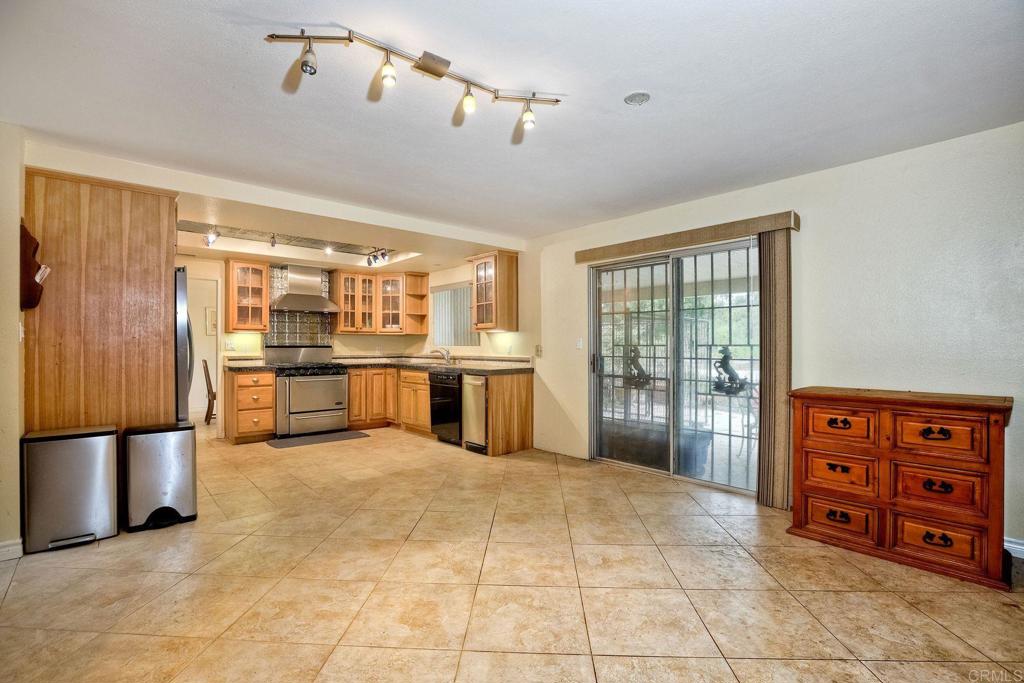 548 Taylor Street Vista, CA 92084 - Photo 17 of 74 a large kitchen with stainless steel appliances granite countertop a refrigerator and a sink