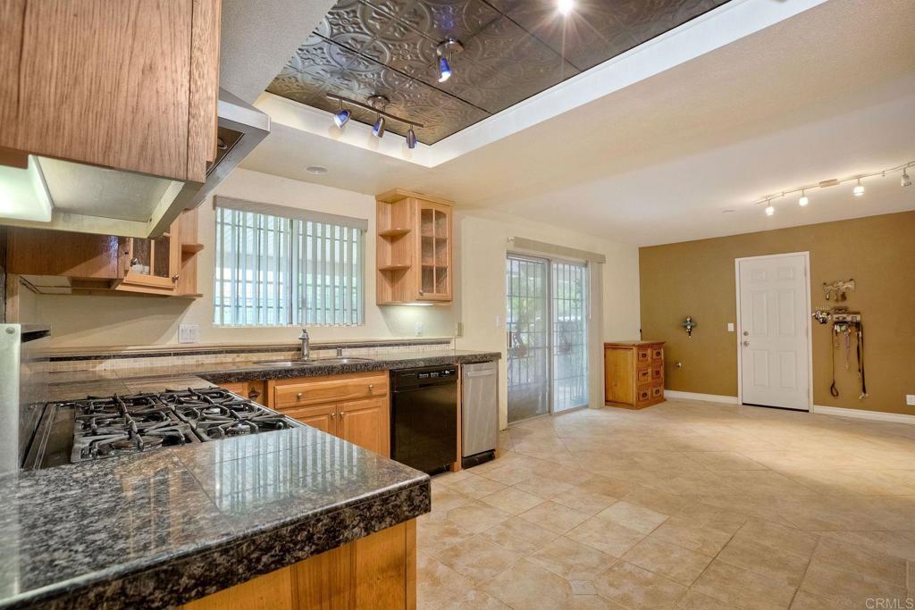 548 Taylor Street Vista, CA 92084 - Photo 21 of 74 a kitchen with stainless steel appliances granite countertop a stove and a sink