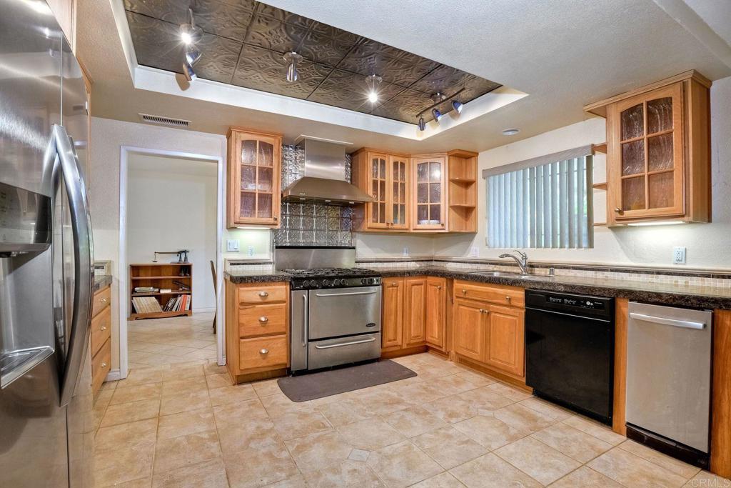 548 Taylor Street Vista, CA 92084 - Photo 23 of 74 a kitchen with stainless steel appliances granite countertop a stove sink and cabinets