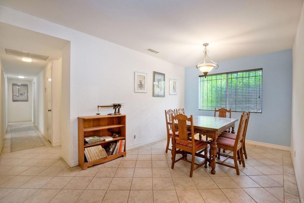 548 Taylor Street Vista, CA 92084 - Photo 24 of 74 a dining room with furniture and a floor to ceiling window
